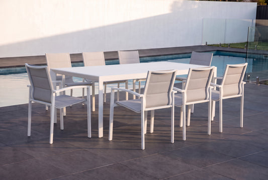 CARDO IX 8-Seater Outdoor Dining Setting - White beside a pool on an alfresco terrace