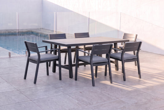 PLATANO VII 6-Seater Outdoor Dining Setting in Black beside a pool on an alfresco terrace