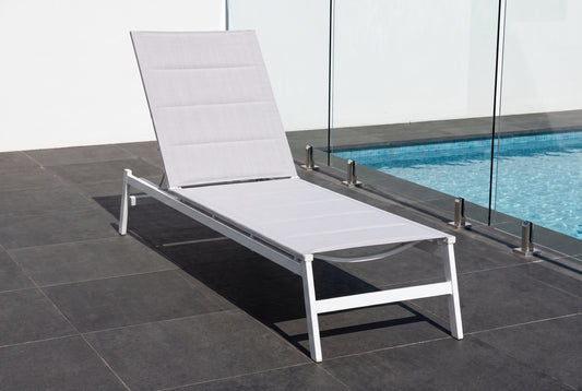 PRIMULA Padded Sunlounge in White beside a pool