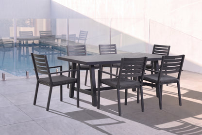 AZALEA VII 6-Seater Outdoor Dining Setting - Black beside a pool on an alfresco terrace