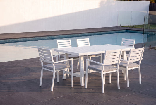 AZALEA VII 6-Seater Outdoor Dining Setting - White beside a pool on an alfresco terrace