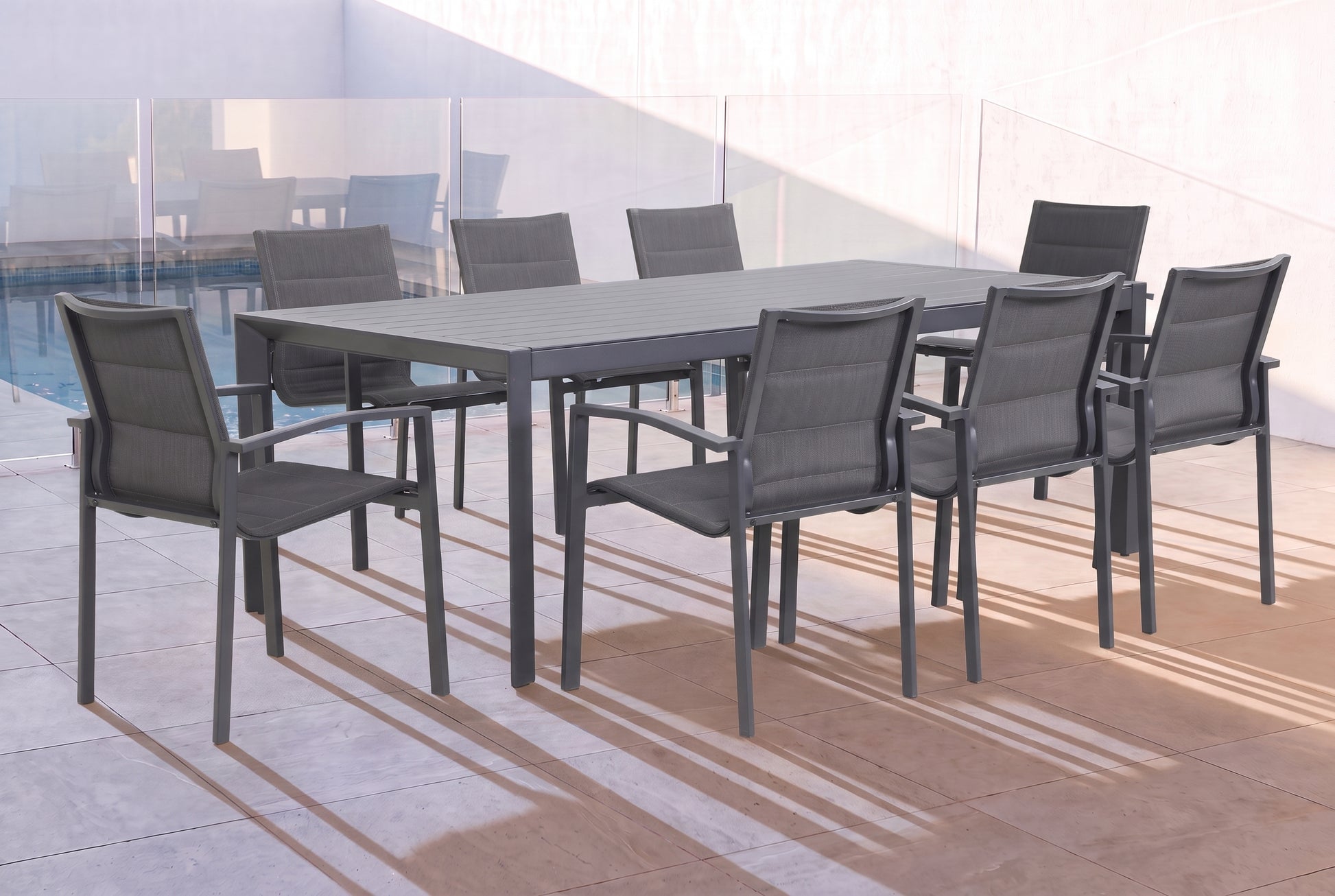 CARDO IX 8-Seater Outdoor Dining Setting - Gunmetal beside a pool on an alfresco terrace