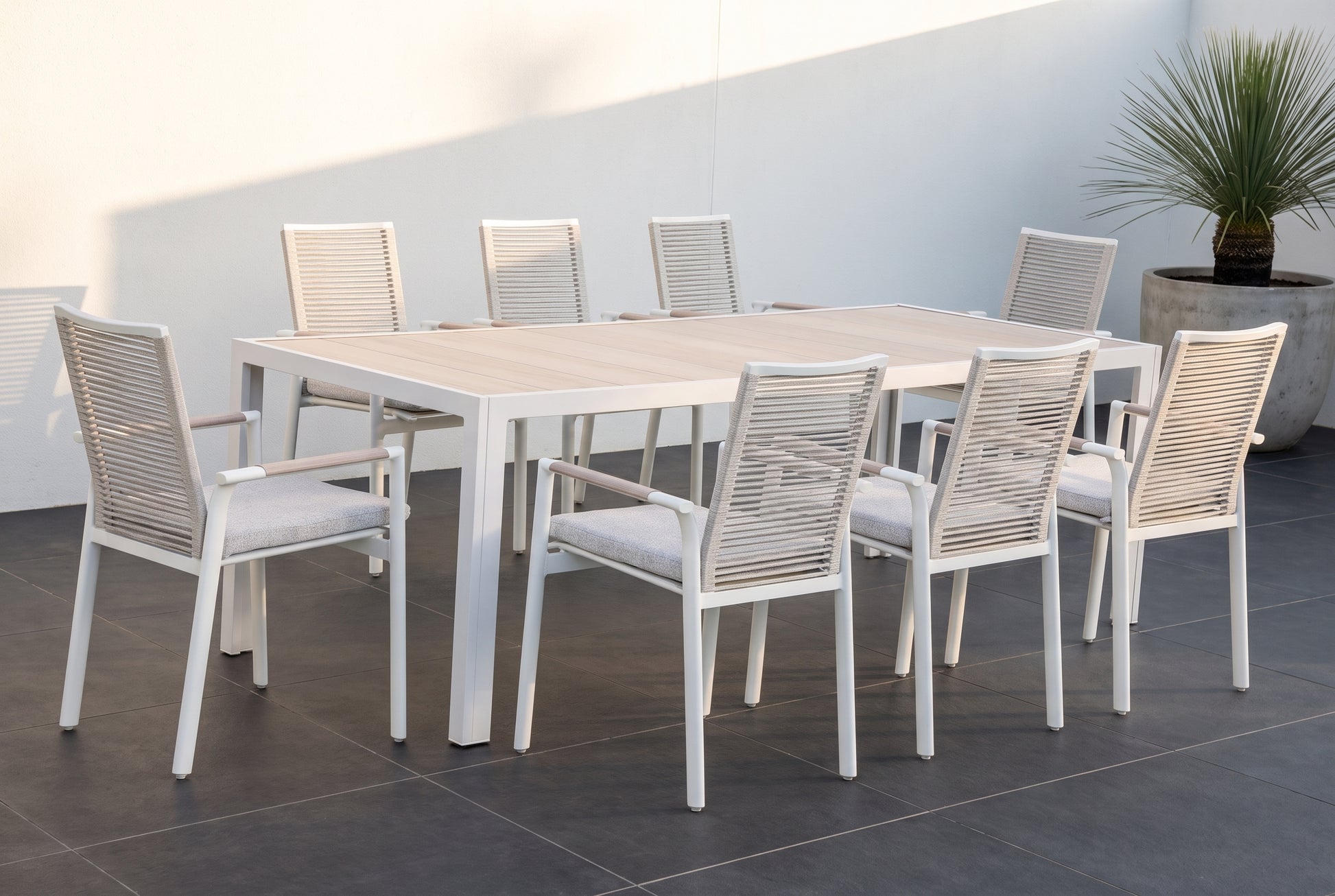 CARRUBO IX 8-Seater Outdoor Dining Setting on a large format dark charcoal porcelain paved terrace