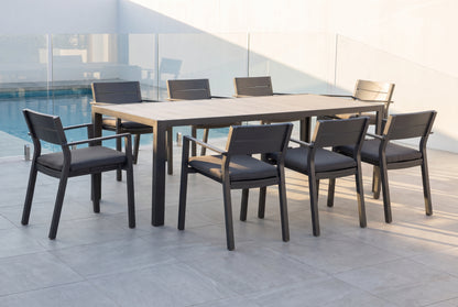 GELSO IX 8-Seater Outdoor Dining Setting in Gunmetal beside a pool on an alfresco terrace of a modern Australian home