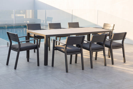 GELSO IX 8-Seater Outdoor Dining Setting in Gunmetal beside a pool on an alfresco terrace of a modern Australian home