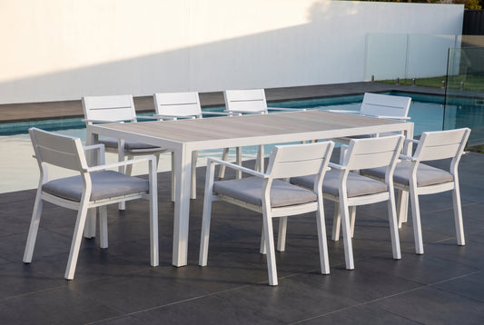 GELSO IX 8-Seater Outdoor Dining Setting in White beside a pool on an alfresco terrace