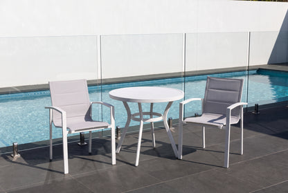 IRIDE III 2-Seater Outdoor Bistro Setting beside a pool on a dark charcoal porcelain paved terrace