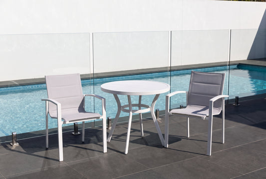 IRIDE III 2-Seater Outdoor Bistro Setting beside a pool on a dark charcoal porcelain paved terrace