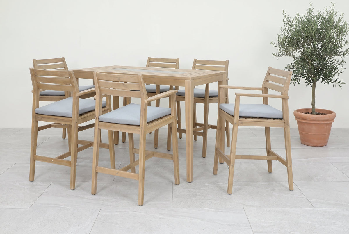 JUNELI VII 6-Seater Outdoor Bar Setting styled on light grey porcelain pavers with a potted olive tree