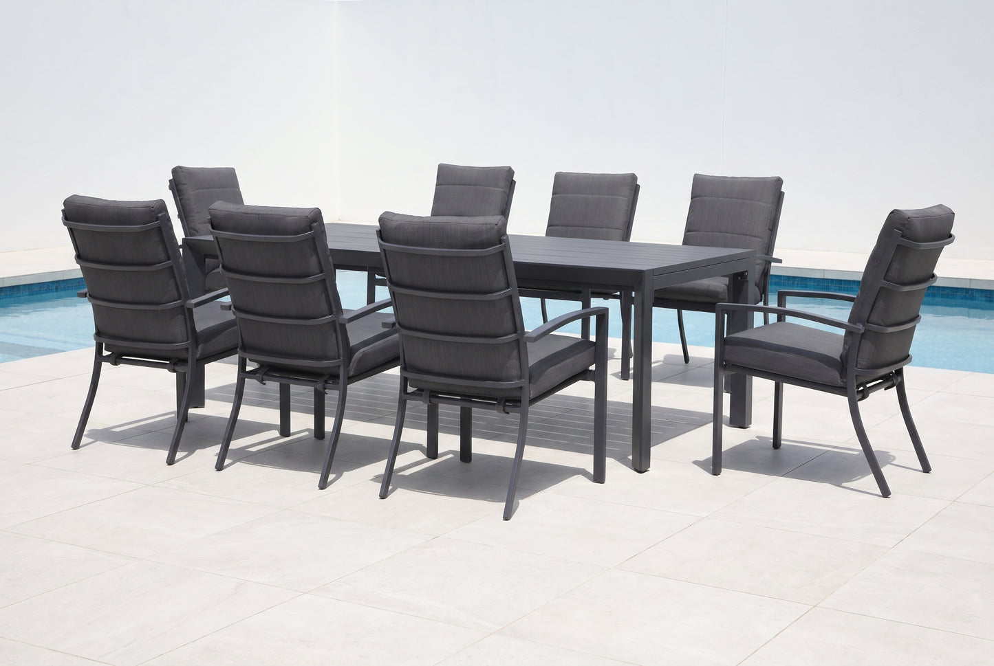 ORTENSIA IX 8-Seater Outdoor Dining Setting in Gunmetal beside a pool on an alfresco terrace