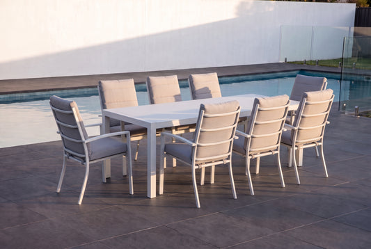 ORTENSIA IX 8-Seater Outdoor Dining Setting in White beside a pool on an alfresco terrace