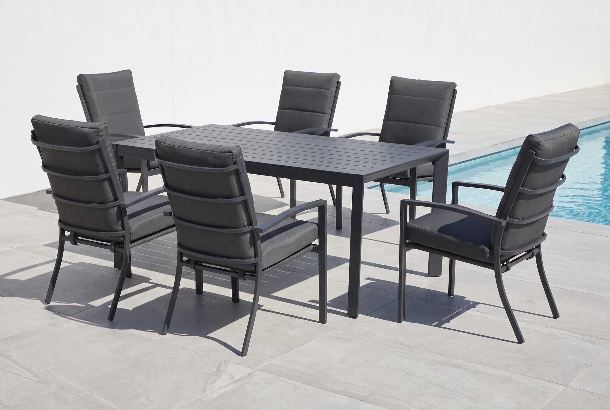 ORTENSIA VII 6-Seater Outdoor Dining Setting beside a pool on an alfresco terrace