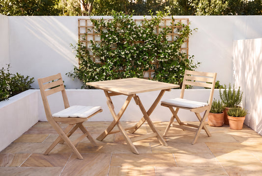 PAPIRO III 2-Seater Foldable Outdoor Bistro Setting in a sandstone paved courtyard of a coastal Australian home