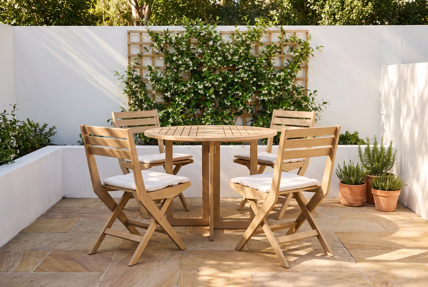 PAPIRO V 4-Seater Foldable Outdoor Dining Setting in a sandstone paved courtyard of a coastal Australian home
