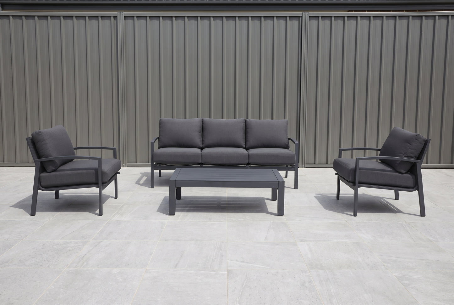 PESCO IV 5-Seater Outdoor Lounge Setting in Gunmetal on a light porcelain paved terrace