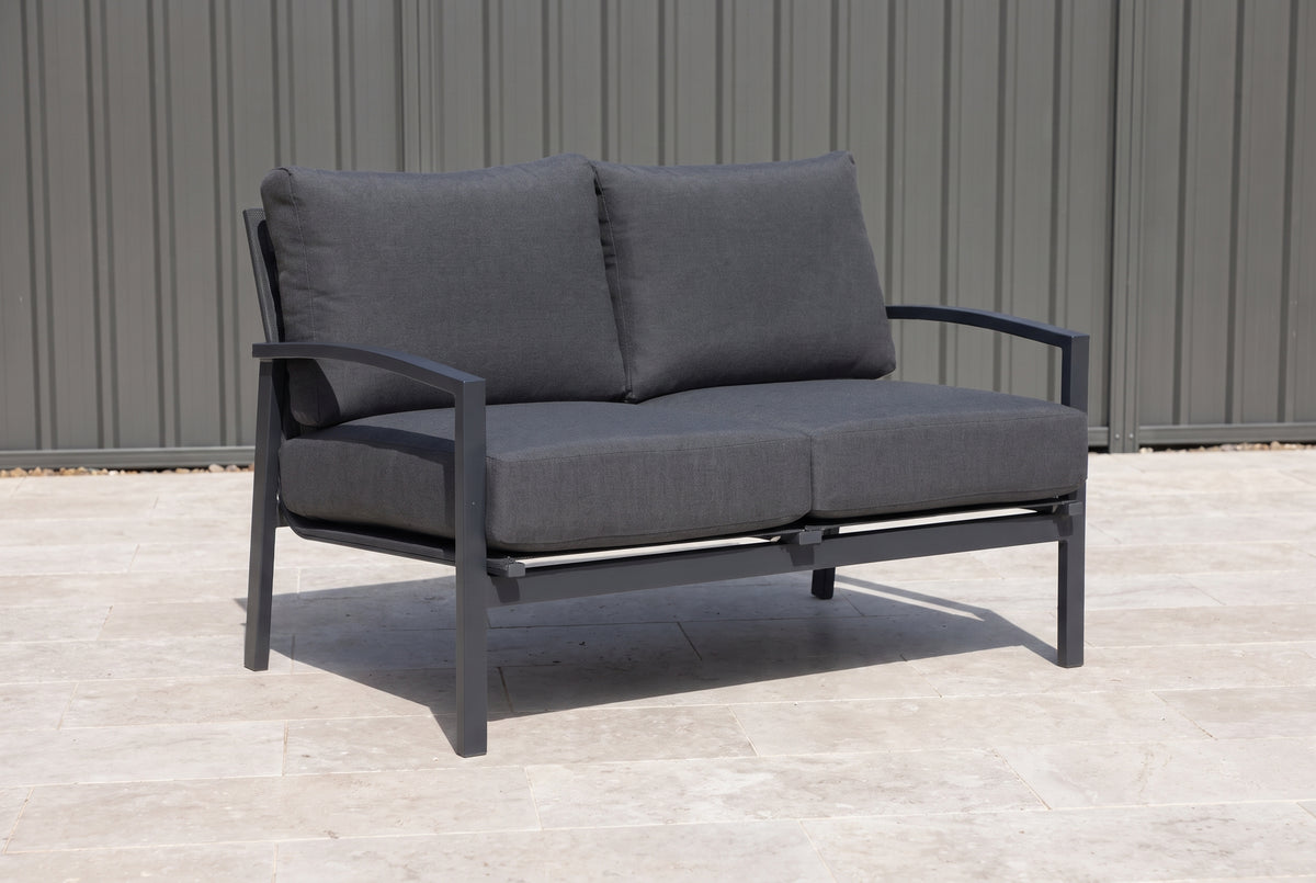 PESCO Outdoor 2-Seater Lounge - Gunmetal on a light porcelain paved terrace of an Australian home
