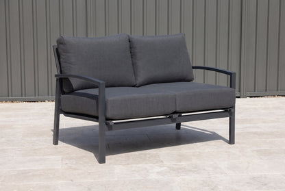 PESCO Outdoor 2-Seater Lounge - Gunmetal on a light porcelain paved terrace of an Australian home