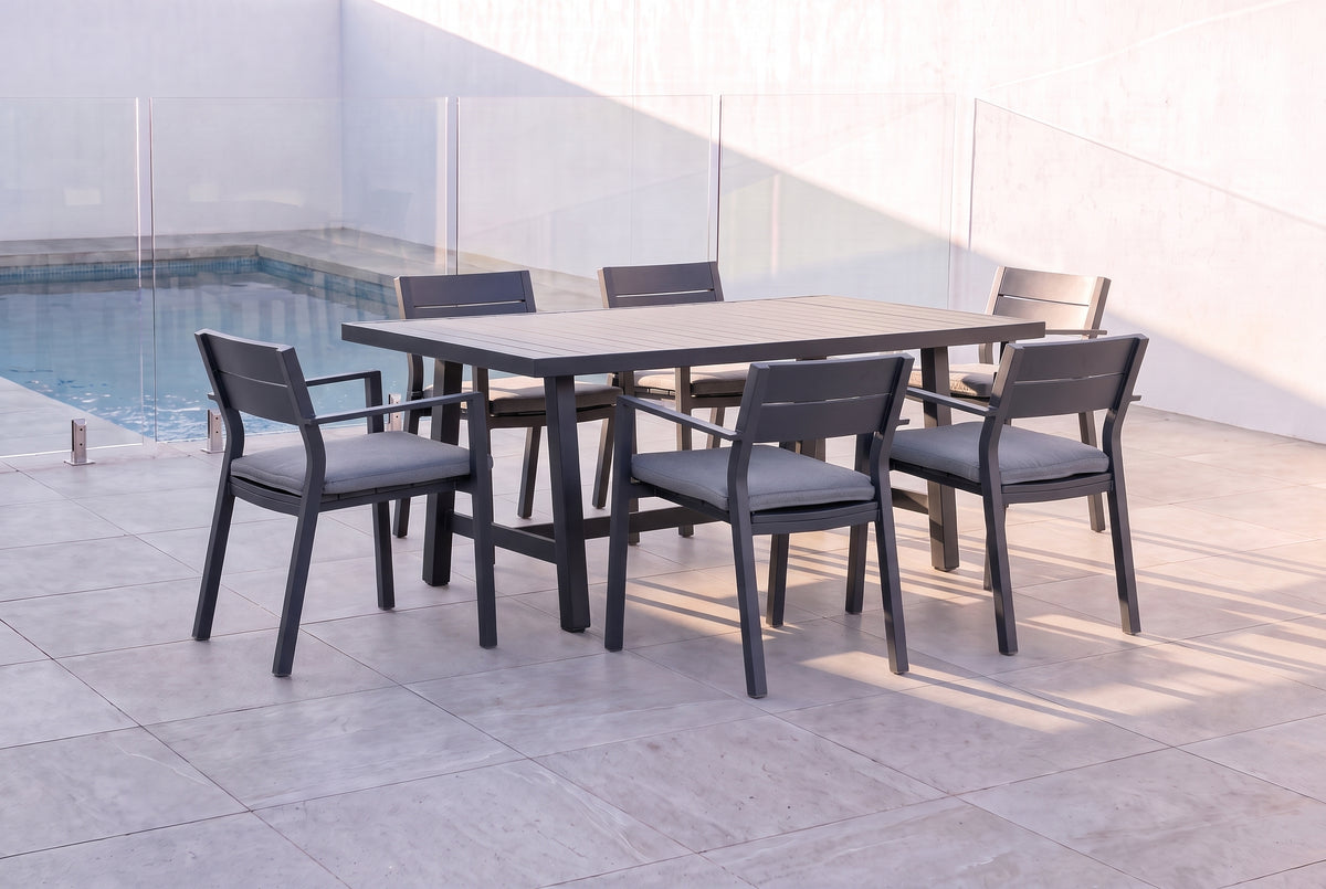 PLATANO VII 6-Seater Outdoor Dining Setting in Black beside a pool on an alfresco terrace