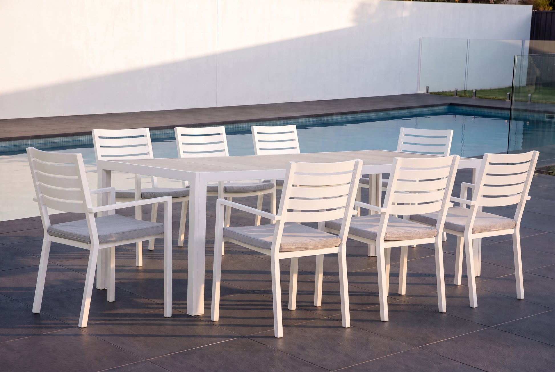 STACHYS IX 8-Seater Outdoor Dining Setting beside a pool on an alfresco terrace