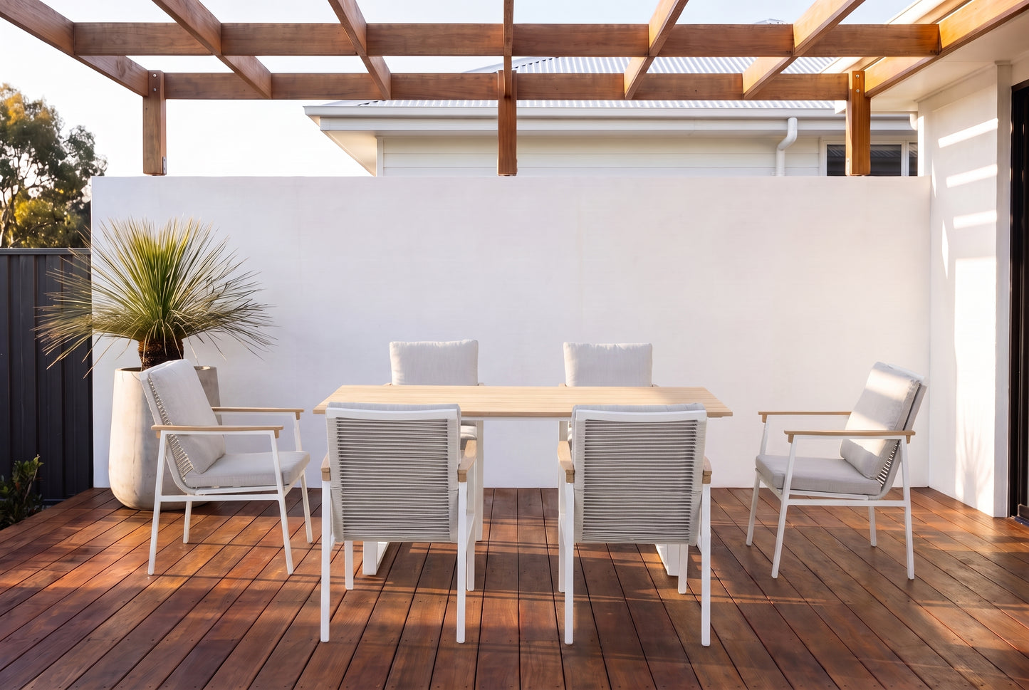 SUSANO VII 6-Seater Outdoor Dining Setting in White on a dark hardwood timber deck