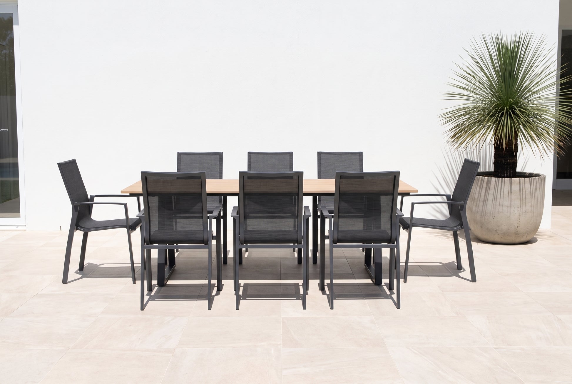SUSINO IX 8-Seater Outdoor Dining Setting on a light porcelain paved terrace