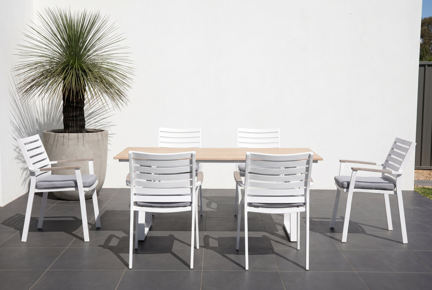 TIARELLO VII 6-Seater Outdoor Dining Setting on a dark charcoal porcelain paved terrace