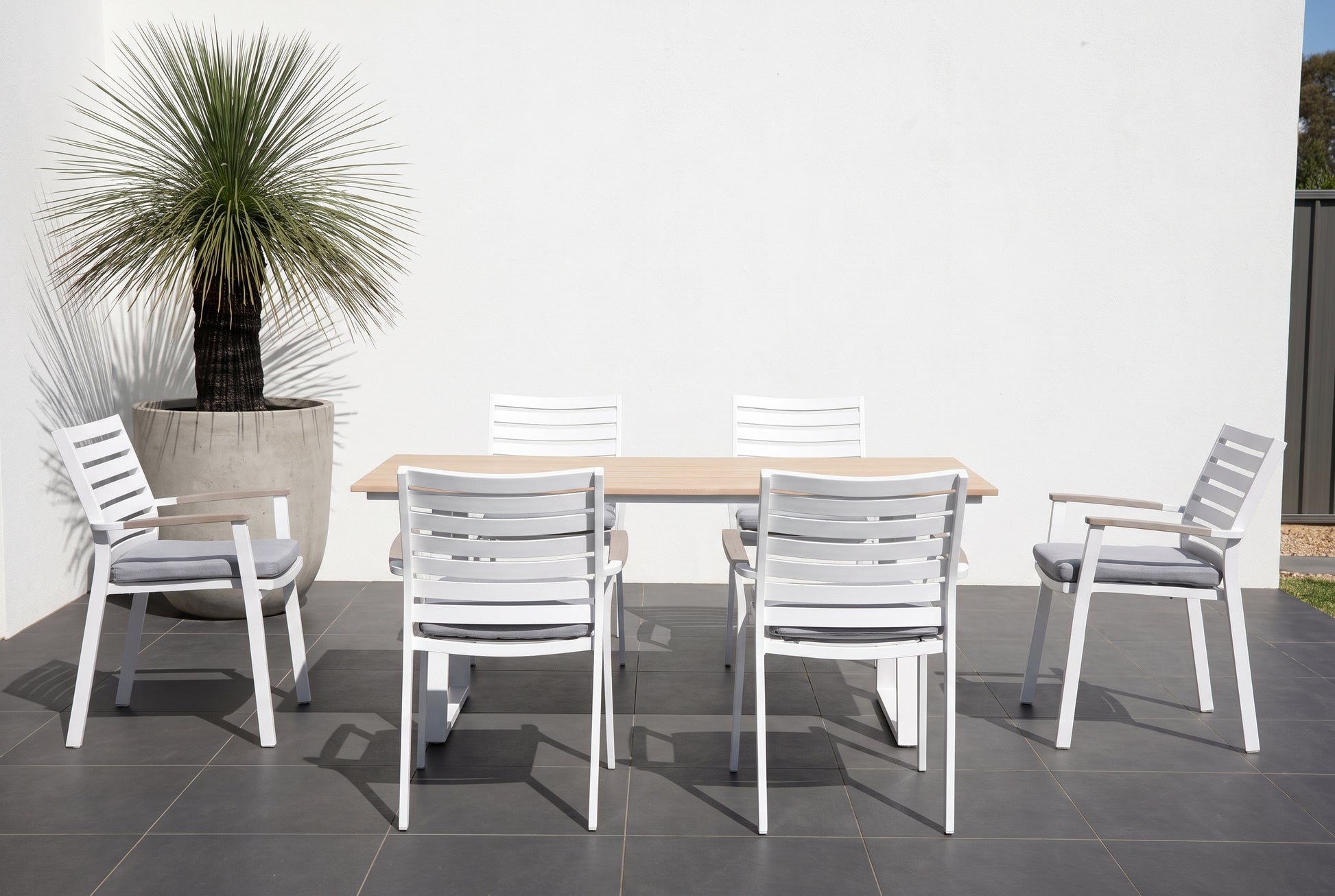 TIARELLO VII 6-Seater Outdoor Dining Setting on a dark charcoal porcelain paved terrace