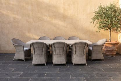 ZINNIA IX 8-Seater Outdoor Dining Setting on a dark charcoal stone paved terrace